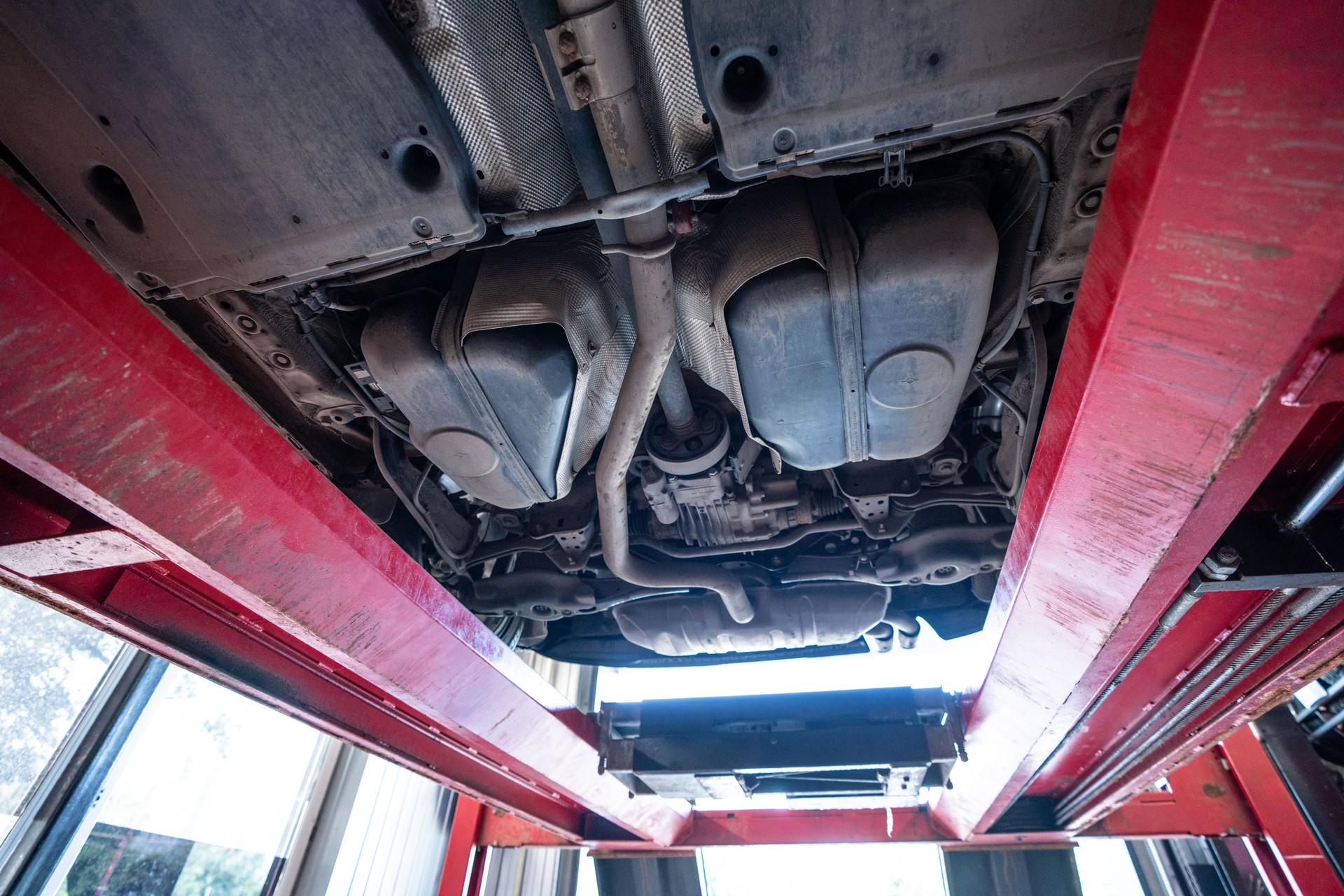 Close-up of car underbody on the lift at car service station